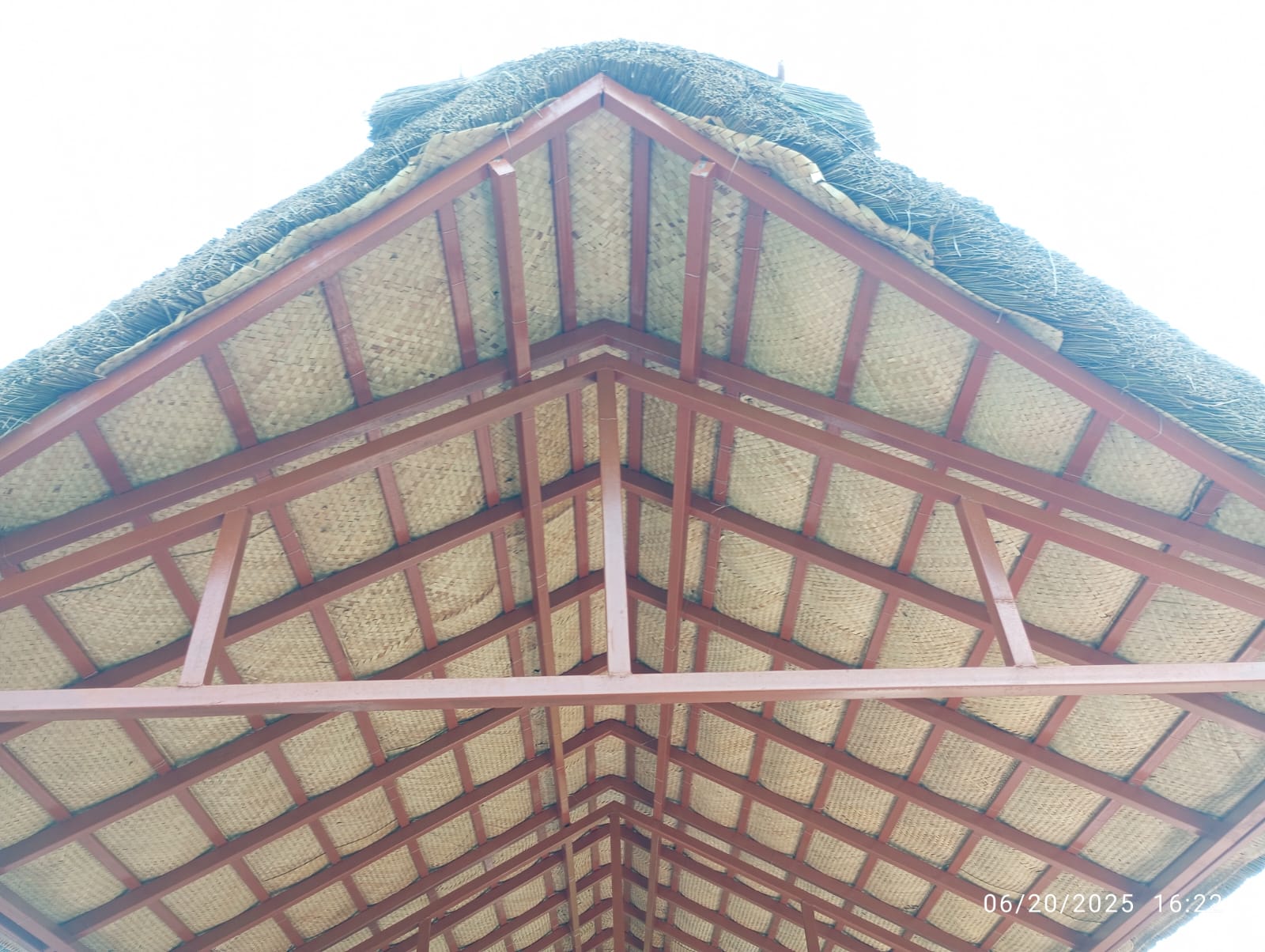 Craftsman weaving coconut palm leaves for a thatched roof